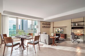 A modern living room with a dining area, large windows, and a city view. - Somerset Chancellor Court Ho Chi Minh City (Ho Chi Minh City)