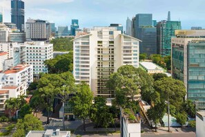 A high-rise building with multiple balconies, surrounded by other buildings and trees. - Somerset Chancellor Court Ho Chi Minh City (Ho Chi Minh City)