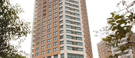 A tall, modern building with a prominent 'Somerset Grand' sign at the base.