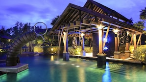 A pool area with a covered structure, a water feature, and a tropical garden setting. - The Slate (Sa Khu)