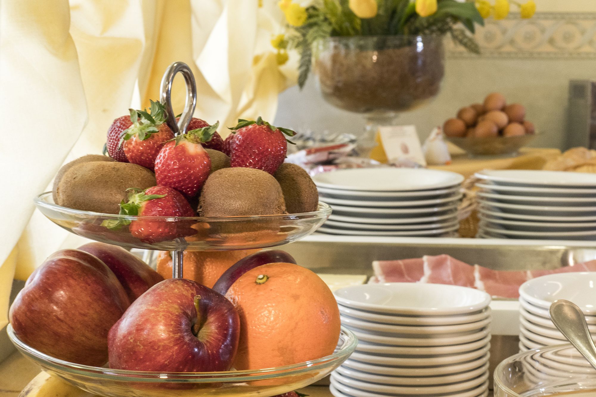 A buffet table with a variety of fruits and pastries.