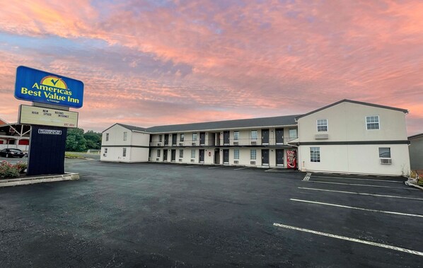 A motel with a sign for 'Americas Best Value Inn by Vantage' and a parking lot.