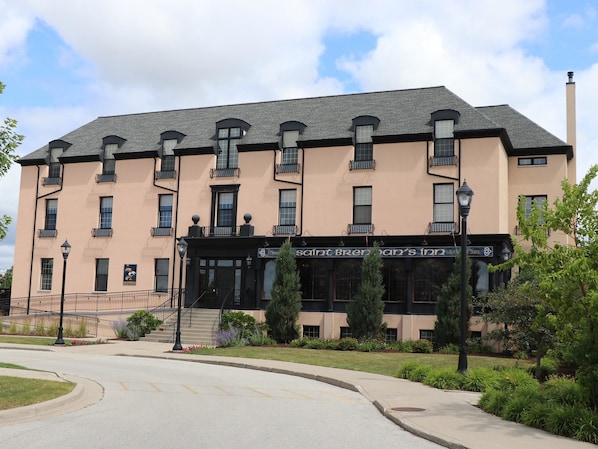 A multi-story building with a flat roof, large windows, and a sign for Saint Brendan's Inn.