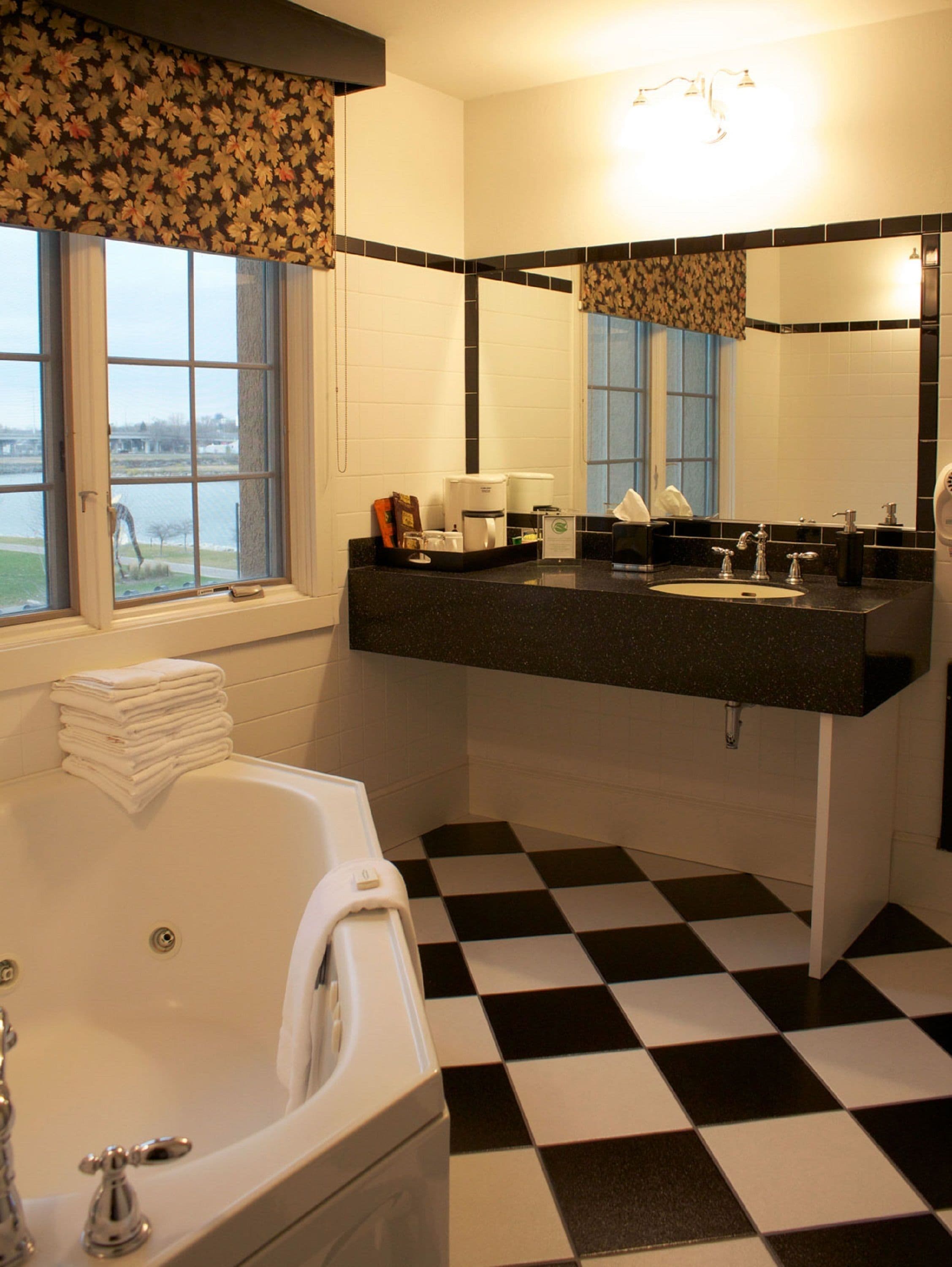 separate bathtub and shower, jetted bath, rainfall showerhead, towels