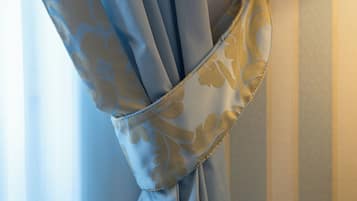 A curtain tied in a knot with a floral pattern.