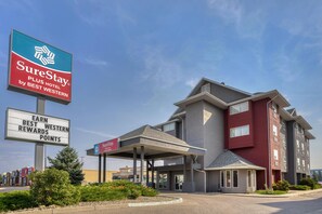 A hotel with a modern design, a covered entrance, and signage for SureStay by Best Western.