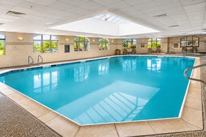 A large indoor swimming pool with clear blue water, surrounded by beige walls and large windows. - Hawthorn Extended Stay by Wyndham Killeen (Killeen)