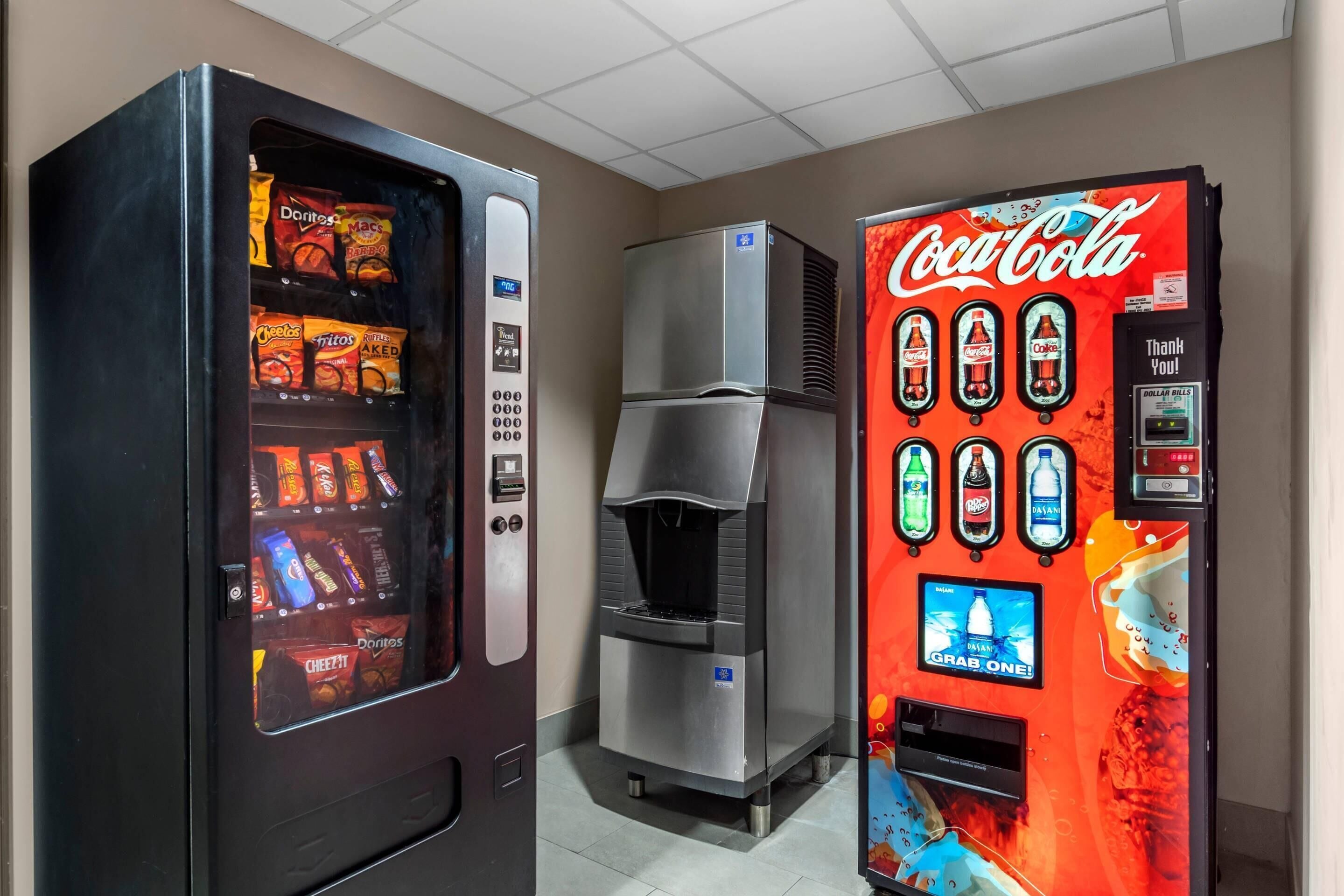 A vending machine with snacks and a Coca-Cola machine.