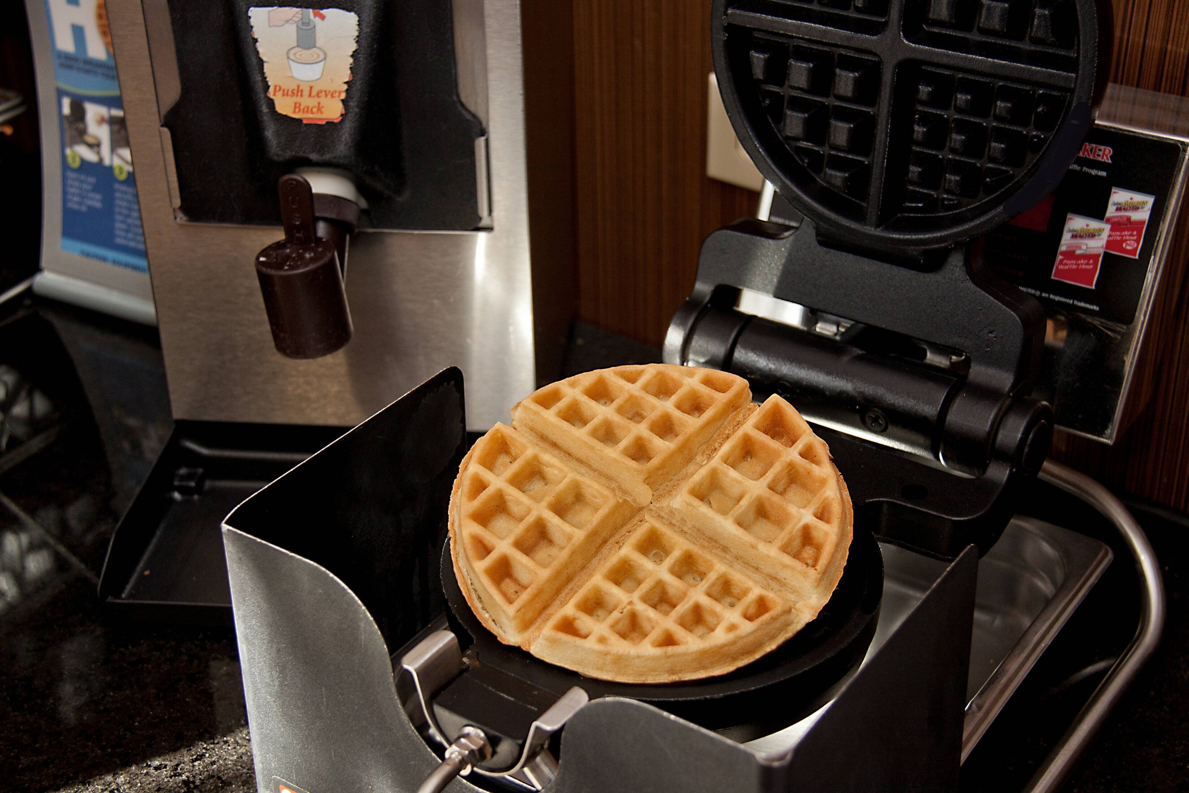 A waffle maker with a waffle inside.