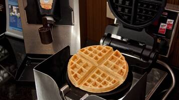A waffle maker with a waffle inside.