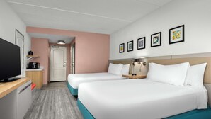 A hotel room with two beds, a TV, a desk, and a bathroom. - Hilton Garden Inn Greensboro (Greensboro)