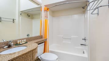 A bathroom with a sink, toilet, and bathtub.