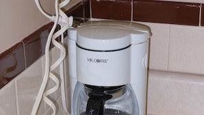 A Mr. Coffee coffee maker on a kitchen counter. - McClellan Inn Anniston (Anniston)
