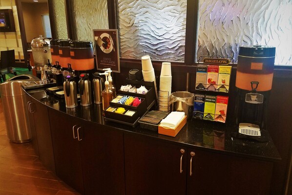 A coffee station with multiple dispensers, a water dispenser, and a variety of coffee and tea options. - SpringHill Suites by Marriott Modesto (Modesto)