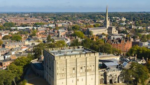 A large, historic building with a prominent tower, surrounded by a densely populated urban area with various buildings and greenery. - Holiday Inn Express Norwich by IHG (Norwich)