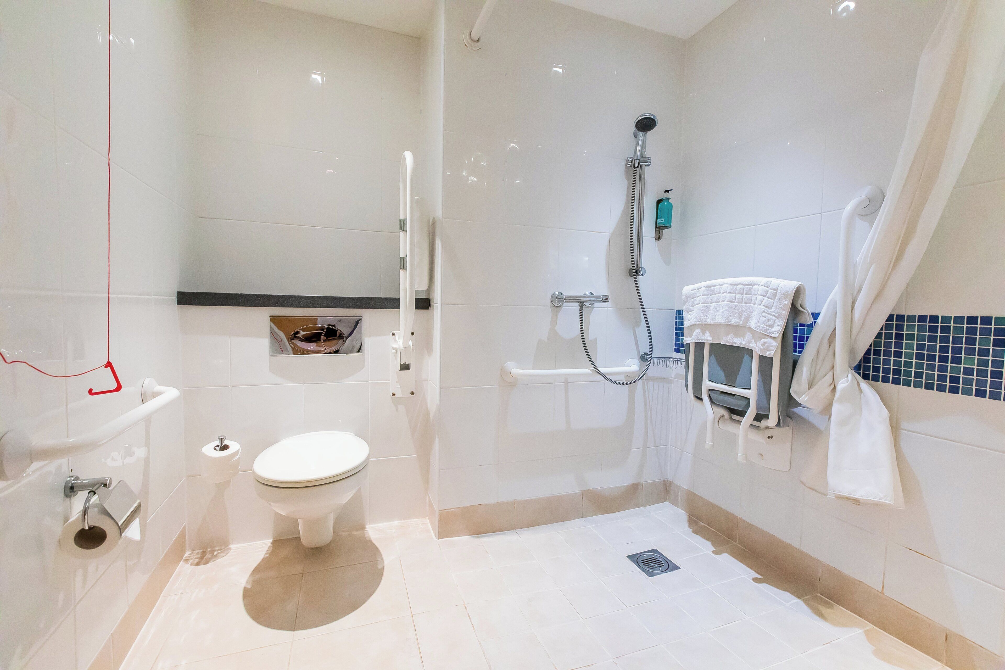 A modern bathroom with a toilet, bidet, and shower.