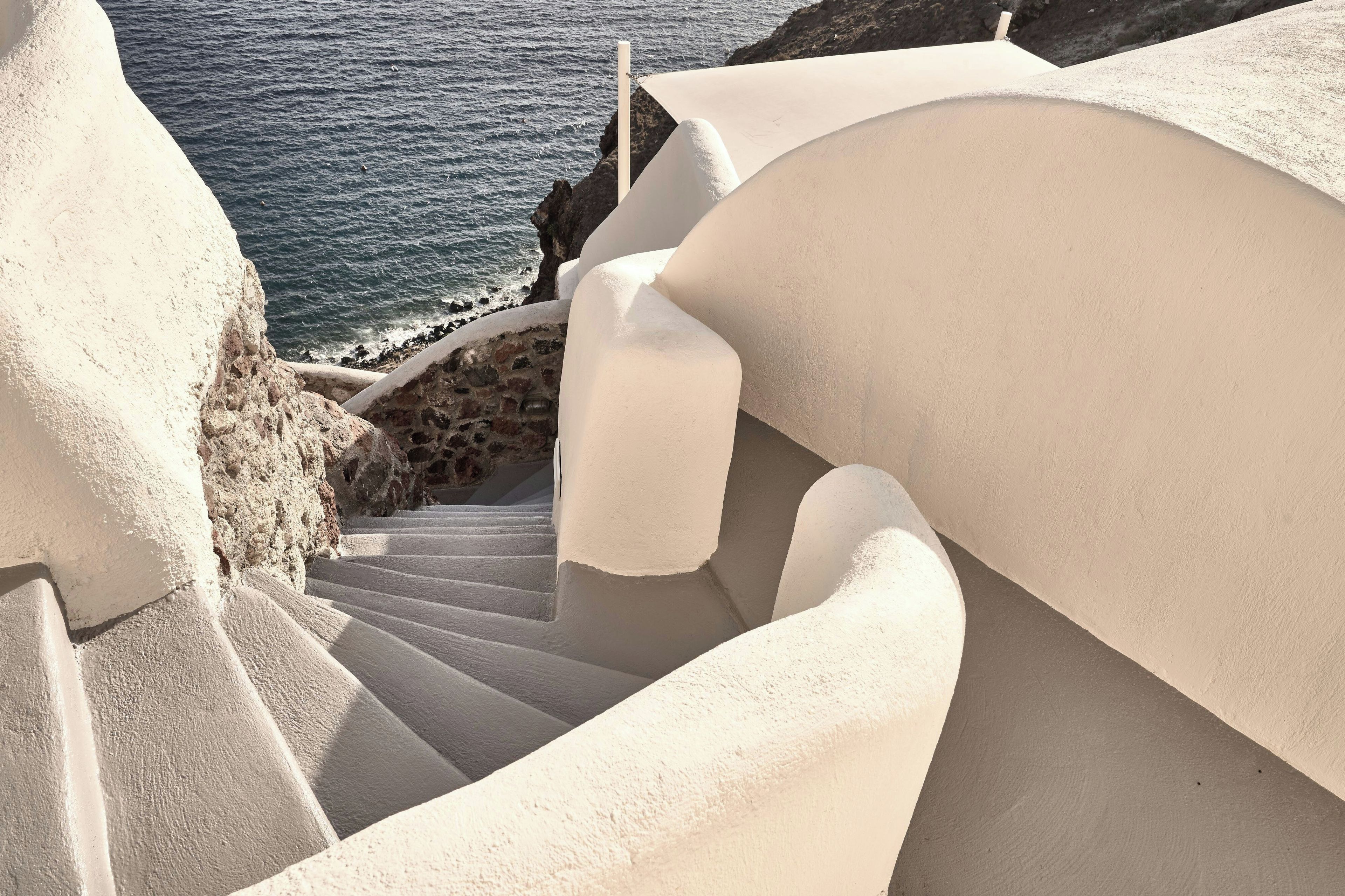 A spiral staircase with a view of the sea.