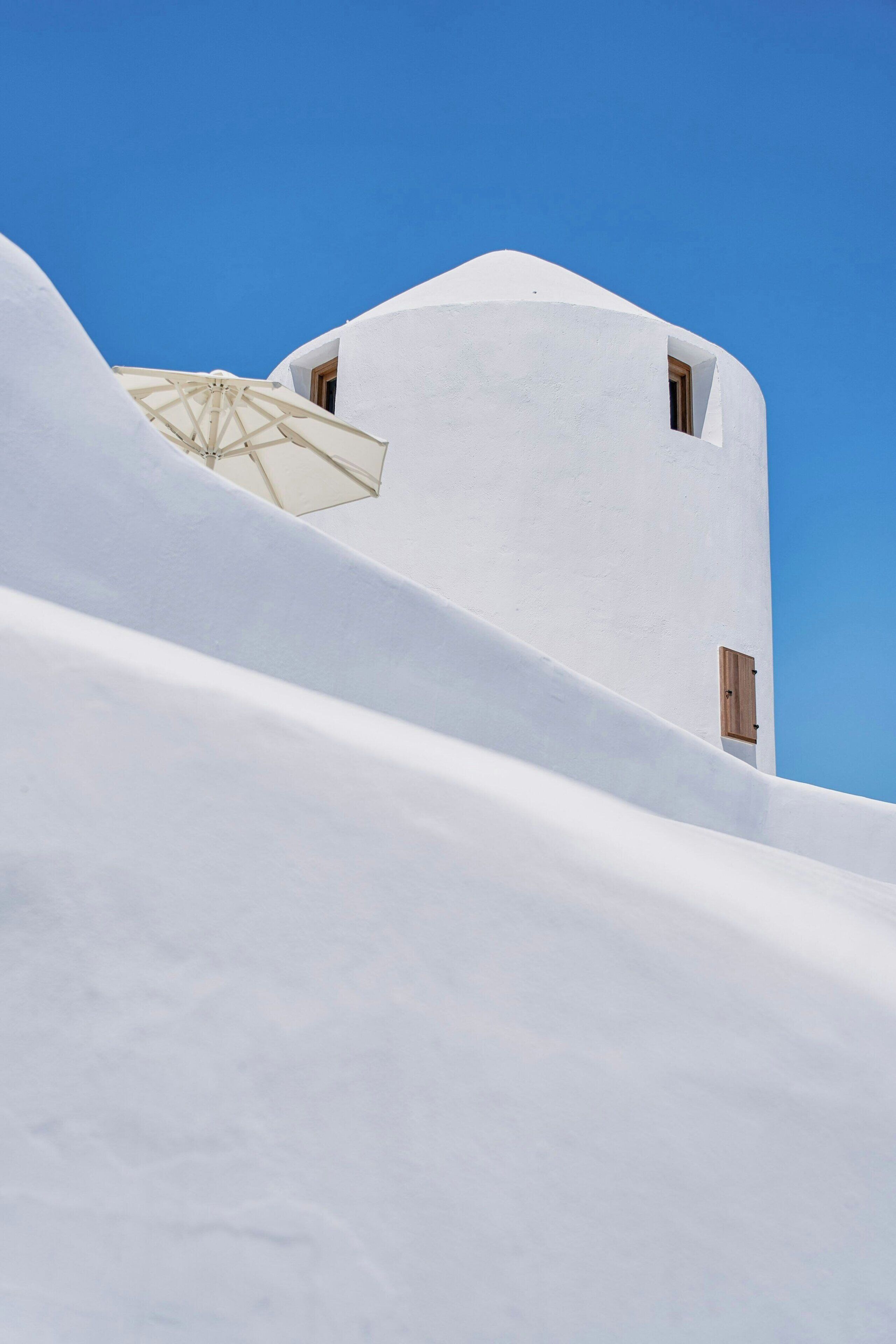 A white building with a sloped roof and a small window.