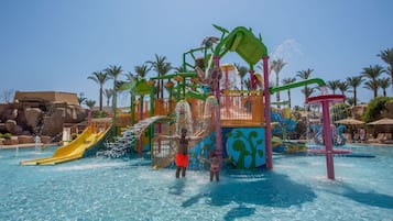 A water park with slides, water features, and palm trees.