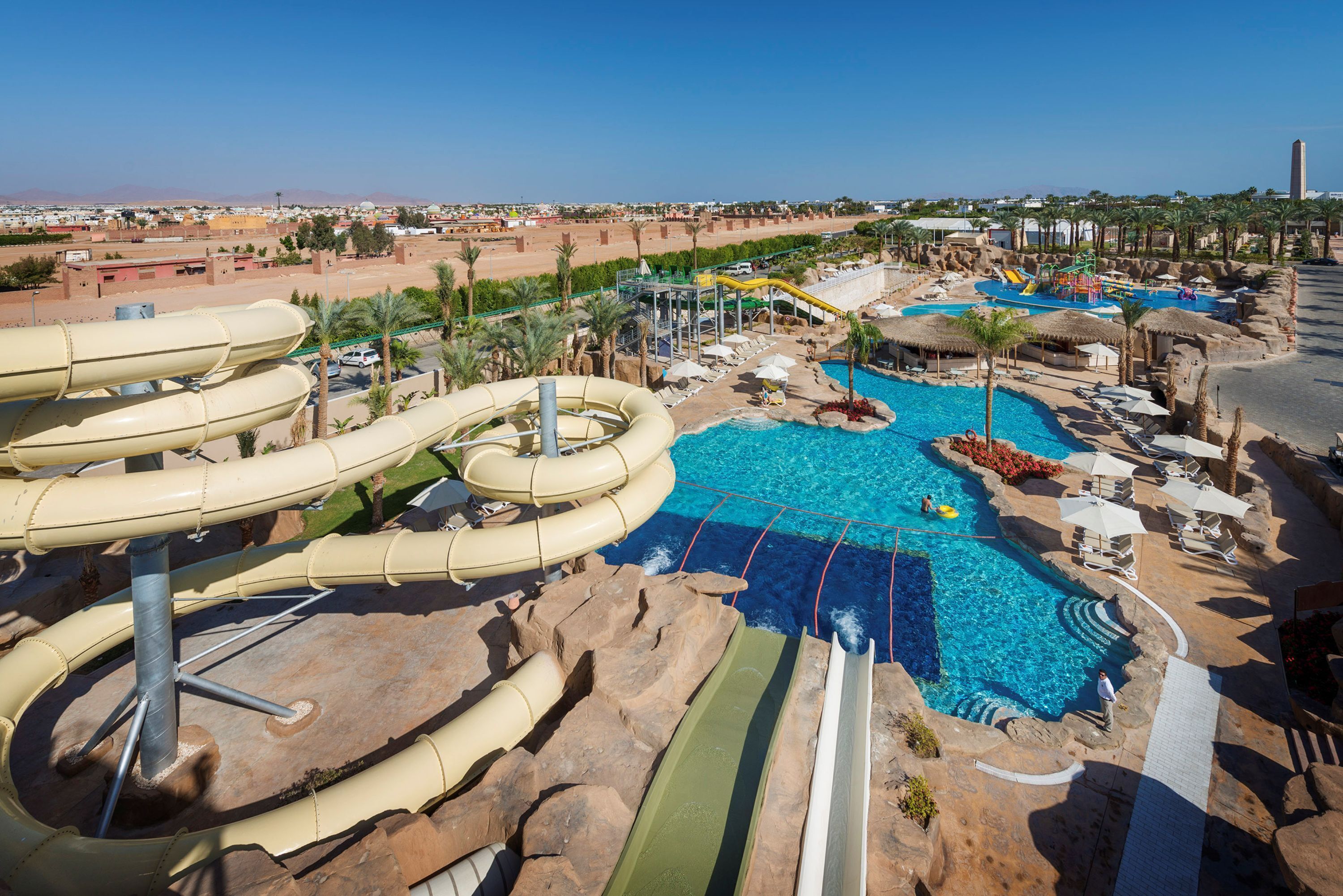 A water park with multiple slides and a large pool area.