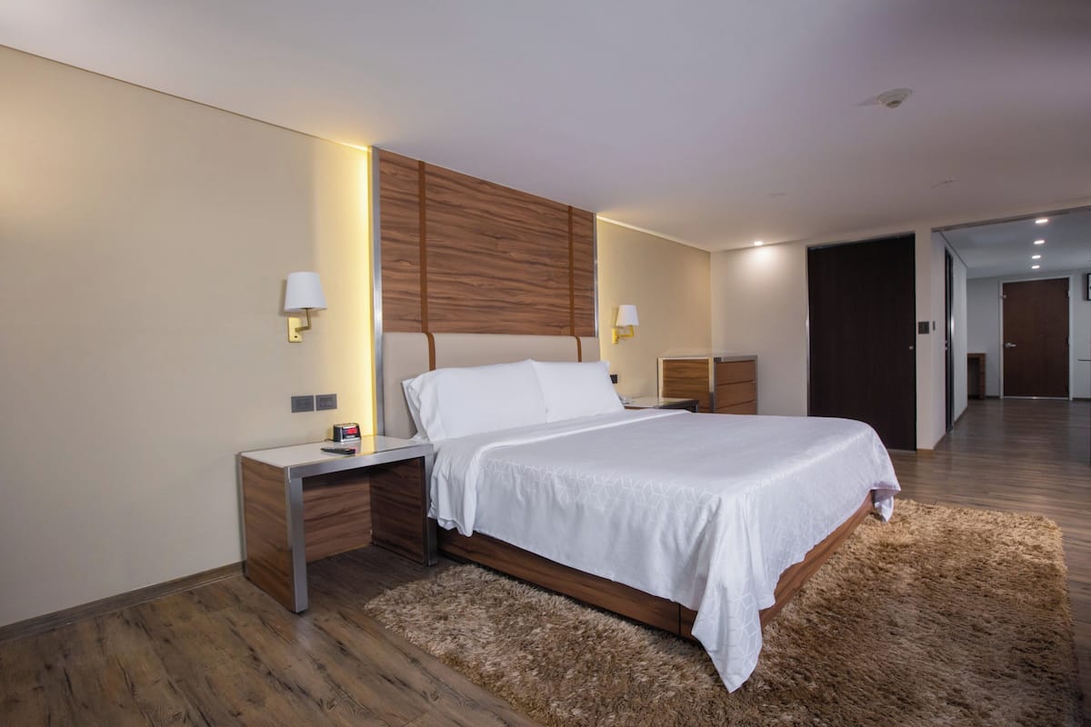Cozy retreat with a large bed, bedside tables, and a plush rug.