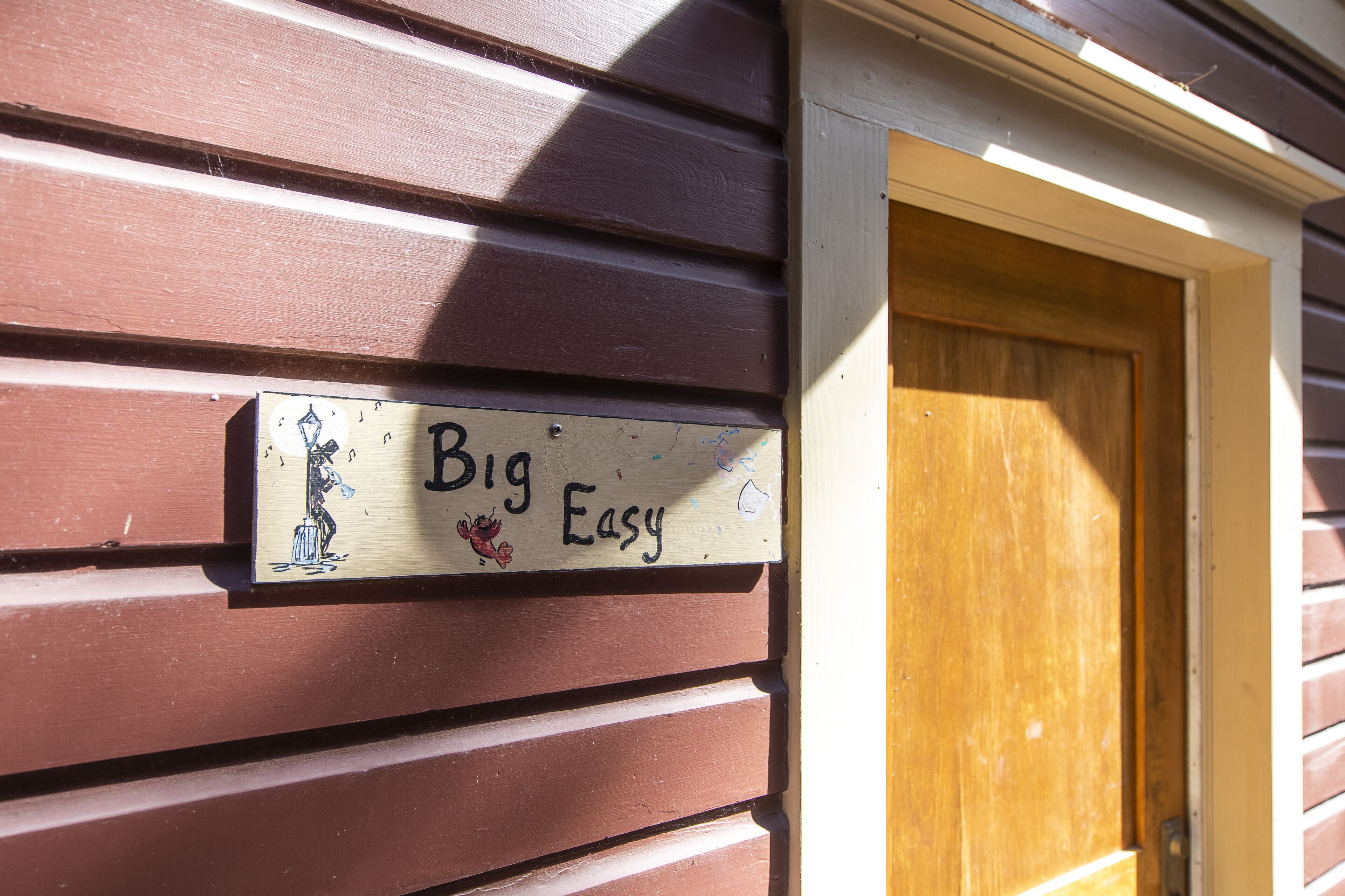 A wooden door with a sign that reads "Big Easy."