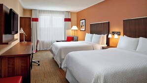 A hotel room with two beds, a desk, a TV, and a window with curtains. - Four Points by Sheraton Moncton (Moncton)