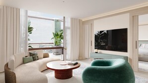 Una sala moderna con sofá, sillón y una mesa redonda de centro.