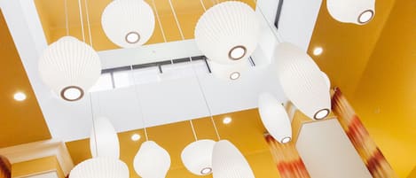 A ceiling with hanging lanterns and a blue square light fixture.
