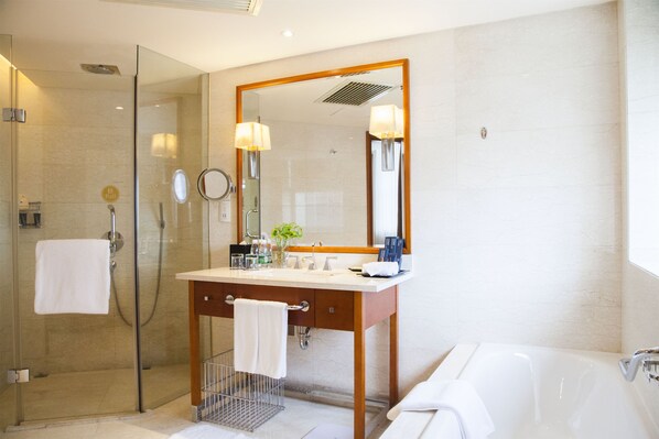 A modern bathroom with a glass-enclosed shower, a wooden vanity with a large mirror, and a white bathtub. - Sheraton Changsha Hotel (Changsha)