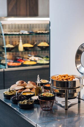 A buffet setup with various food items and a self-service fryer. - Skyline Hotel Jerusalem (Jerusalem)