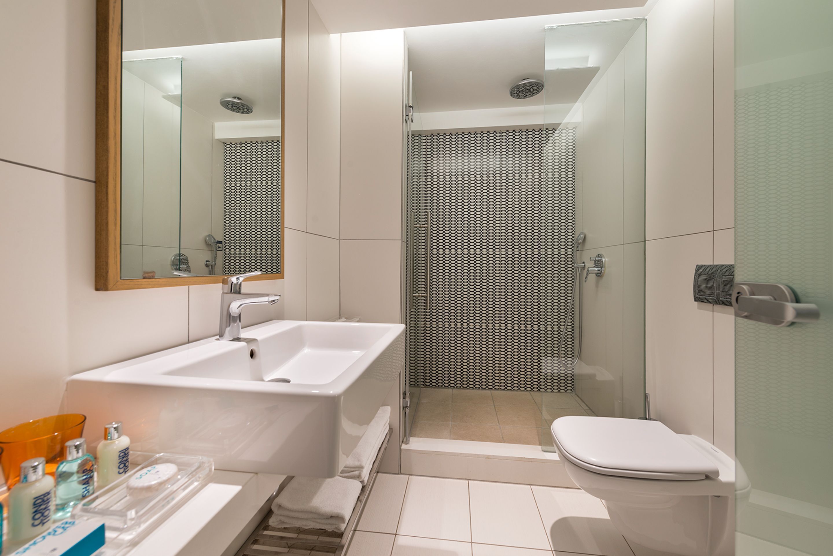 designer toiletries, hair dryer, towels