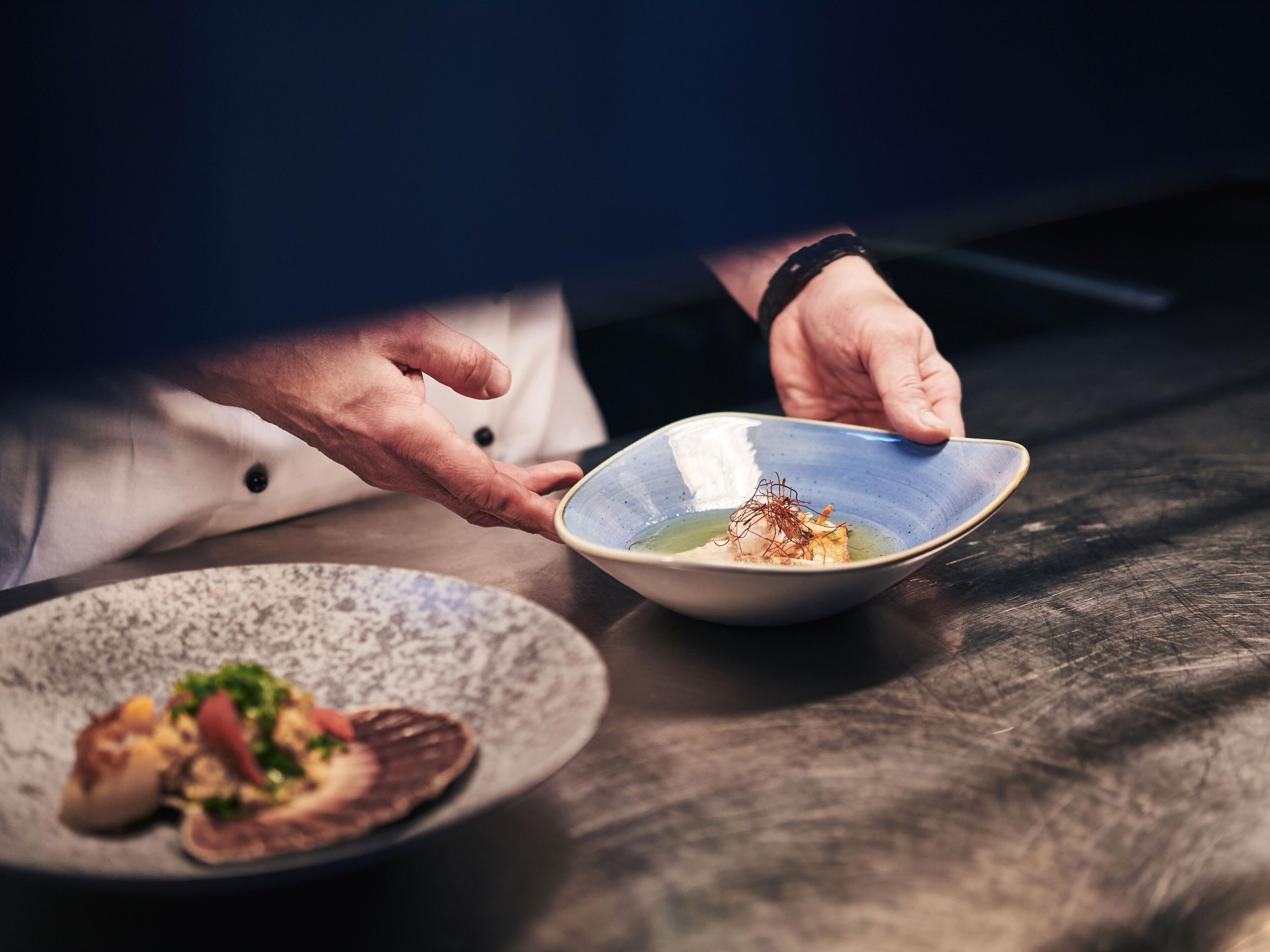 A person serving food from a bowl.