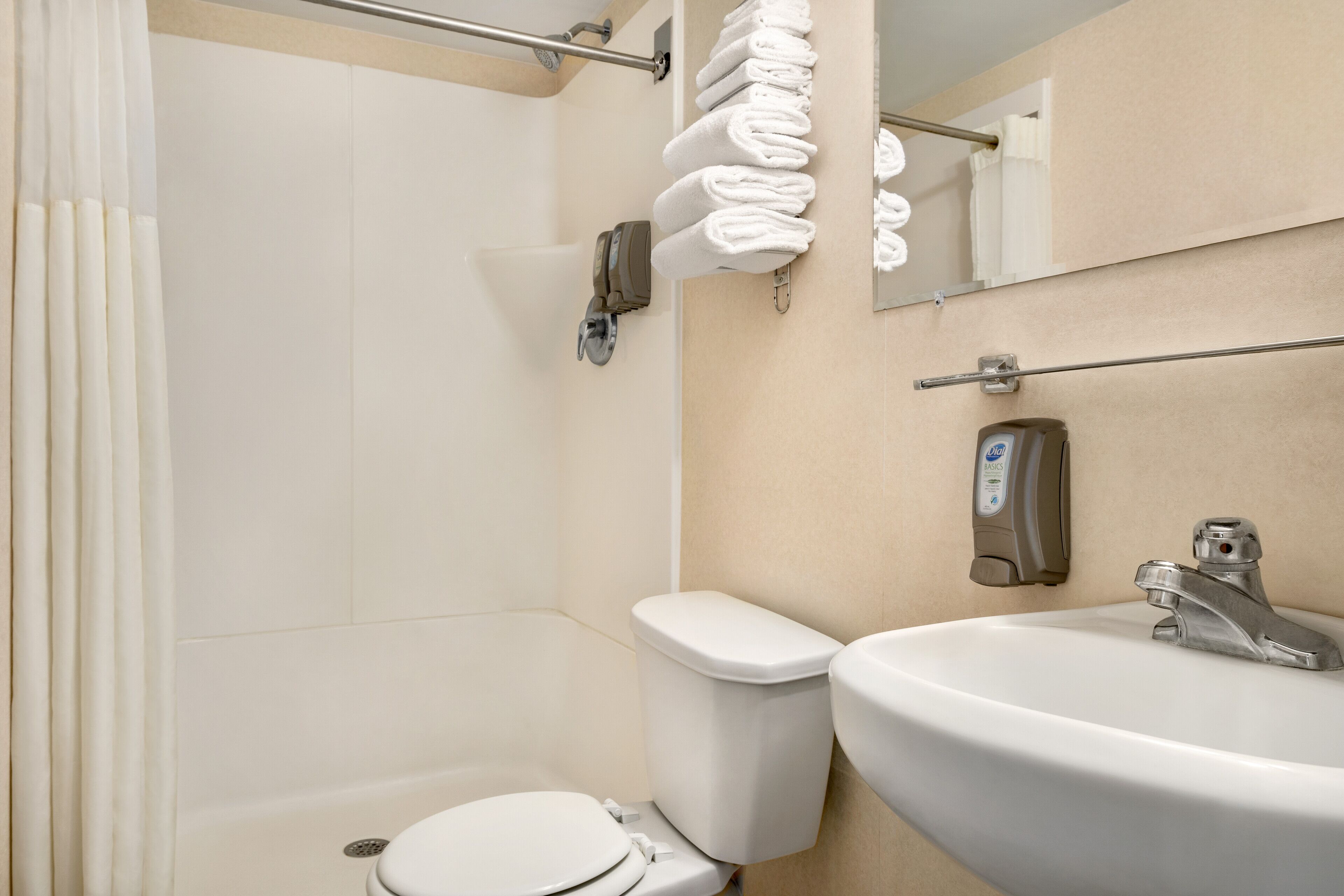 A bathroom with a toilet, sink, and towel rack.