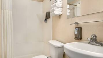 A bathroom with a toilet, sink, and towel rack.