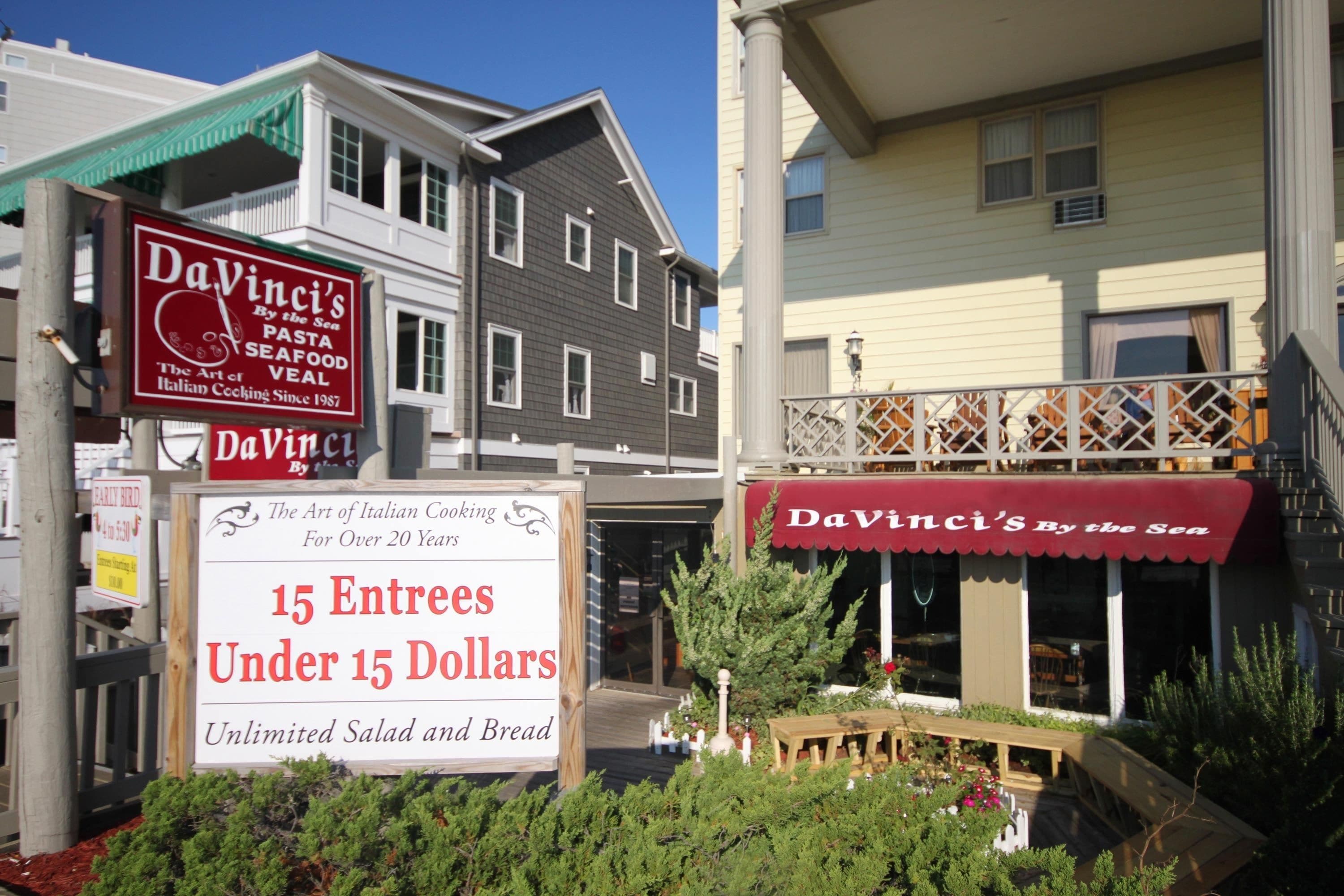 A restaurant named DaVinci's by the sea with a sign offering 15 entrees under $15.