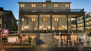 A historic building with a prominent entrance, a balcony, and a sign reading "Harrison Hall". - Harrison Hall Hotel (Ocean City)