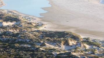Enjoy a serene beach experience with calm waters and open dunes.