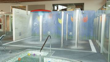 Relax and play in this vibrant water play area featuring a central water feature and colorful surroundings.