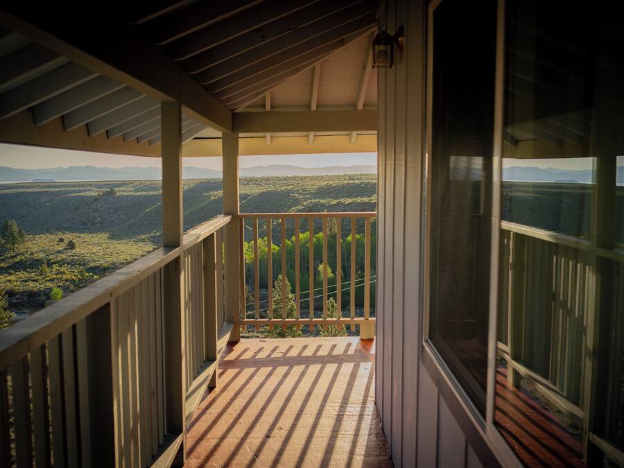 A balcony with a view of a mountainous landscape.