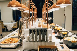 A buffet setup with various food stations and utensils. - Holiday Inn Express Shanghai Putuo by IHG (Shanghai)
