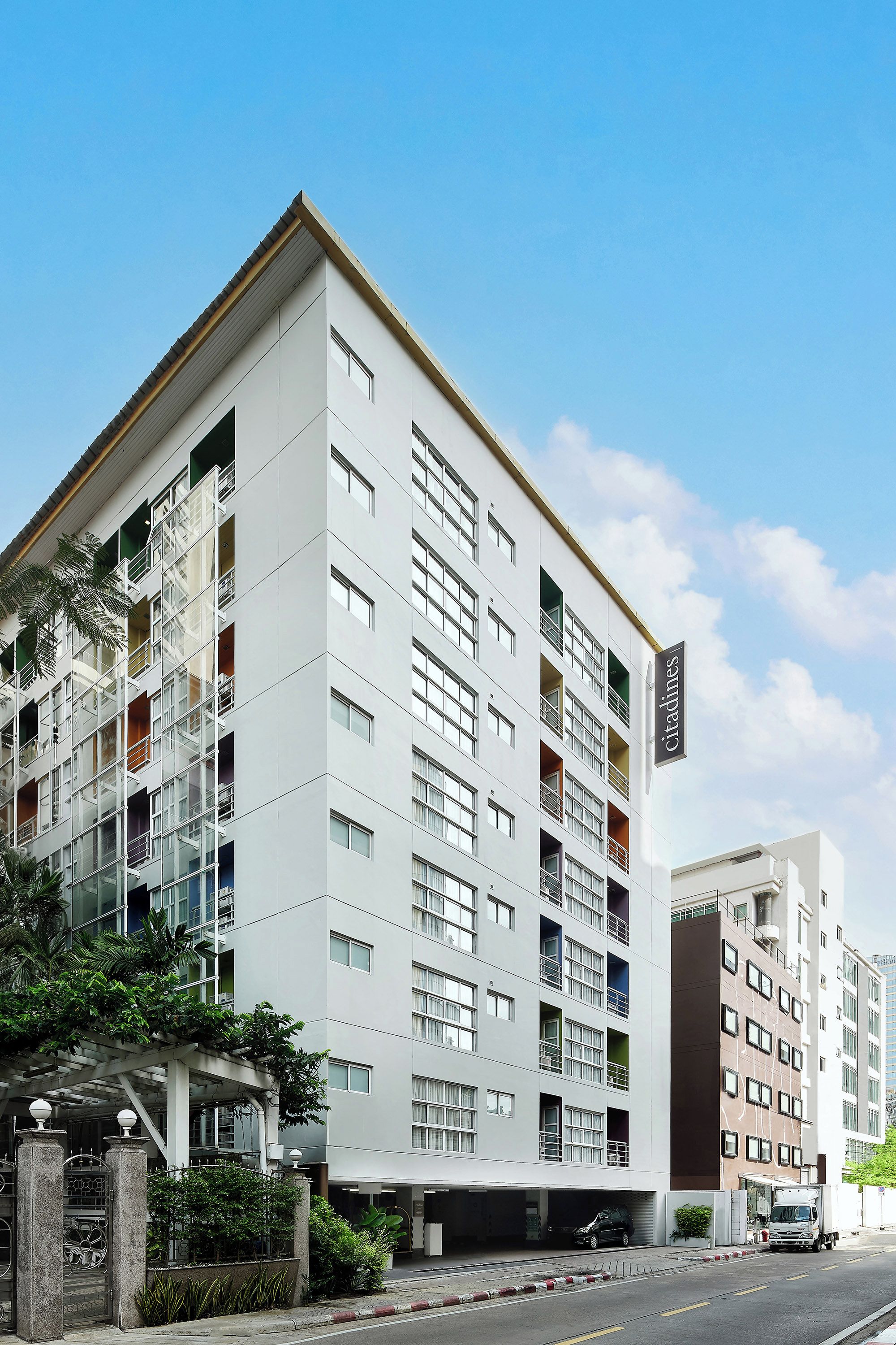 A multi-story building with a modern architectural design, featuring a series of balconies and windows.