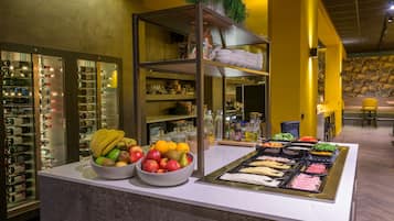 A buffet area with a variety of food items and a wine cooler.