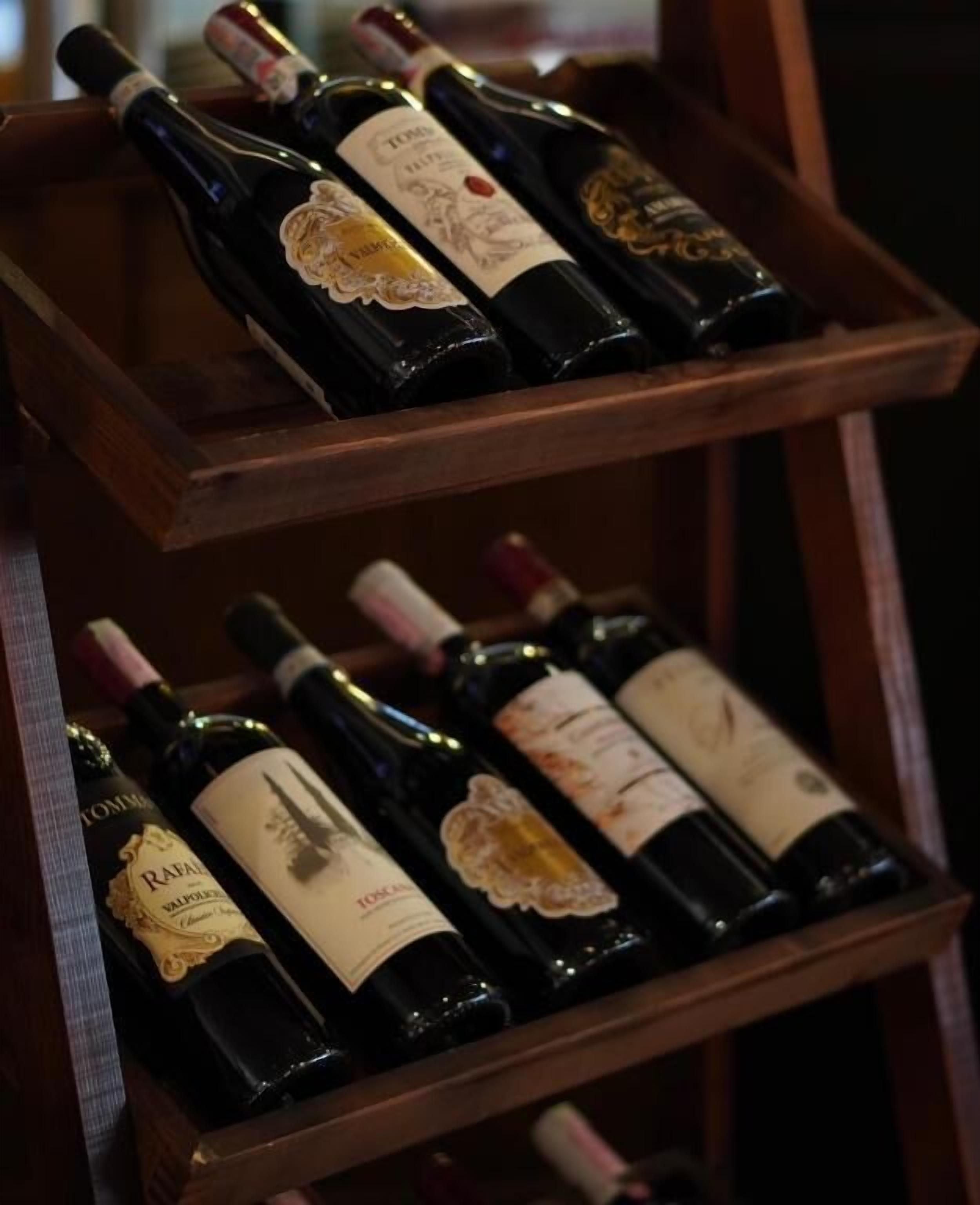 A wooden wine rack holding several bottles of wine.