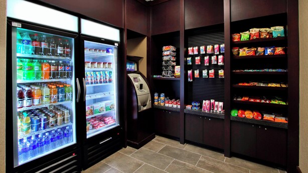 A self-service kiosk area with beverage dispensers, snack shelves, and an ATM. - Residence Inn by Marriott DFW Airport North/Grapevine (Grapevine)