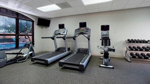 A gym with treadmills, a stair climber, and a bench press. - Residence Inn by Marriott DFW Airport North/Grapevine (Grapevine)