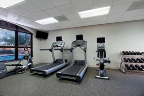 A gym with treadmills, a stair climber, and a bench press. - Residence Inn by Marriott DFW Airport North/Grapevine (Grapevine)