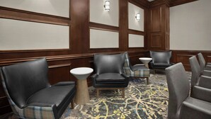 A hotel room with a seating area featuring leather chairs, a small round table, and a patterned carpet. - Residence Inn by Marriott DFW Airport North/Grapevine (Grapevine)