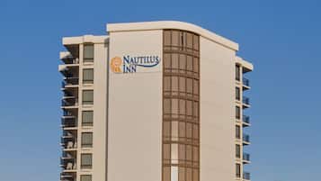 A tall, modern hotel with a prominent sign reading "Nautilus Inn."