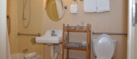 A bathroom with a bathtub, a sink, a toilet, a shower, and a towel rack.
